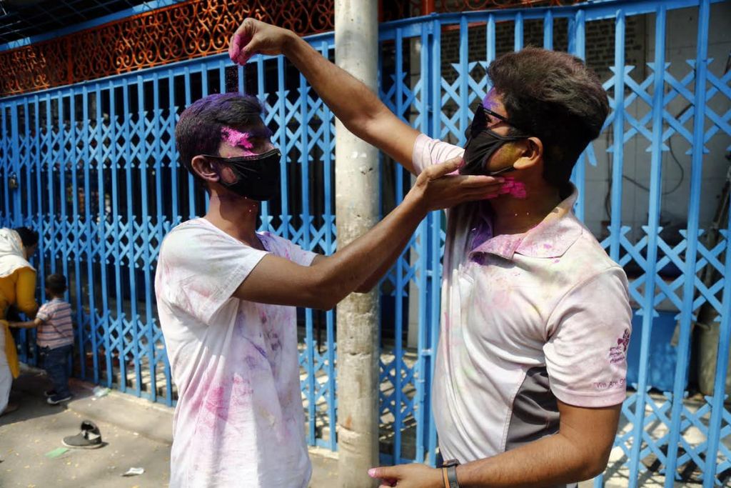 Celebrating Holi festival in medical face masks in Dhaka, Bangladesh, 9 March 2020. Monirul Alam/EPA-EFE