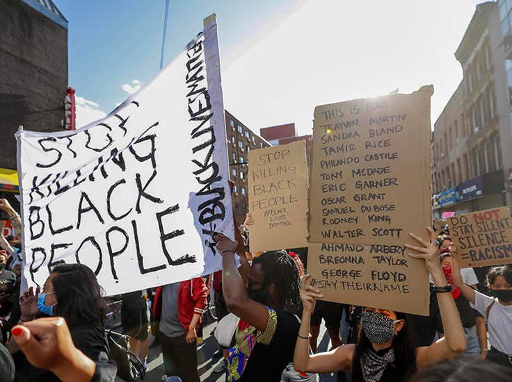 Protesters with signs. Justin Lane/EPA